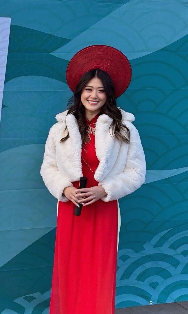 Lisa Nguyen in a red áo dài hosting Lunar New Year San Jose